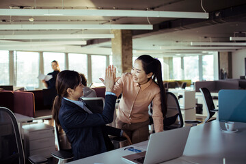 Colleagues Celebrating Success with a High-Five in the Office