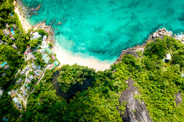 Aerial view Top down seashore. Beautiful azure sea surface in sunny day summer background Amazing seascape top view seacoast at Anse Solei Beach, Mahe Seychelles