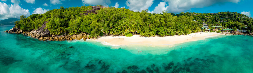 Panorama of Paradise Sunny beach with palms and turquoise sea. Summer vacation and tropical beach concept. Seyshelles, Anse Solei