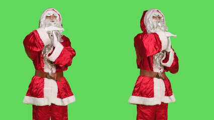 Saint nick cosplay shows timeout symbol, posing in festive seasonal costume over greenscreen...