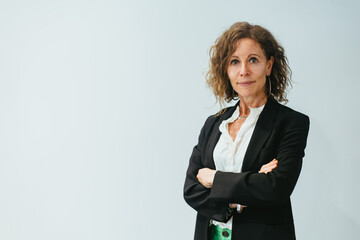 Confident Businesswoman: Woman 50+ Crosses Arms in White Background Shot