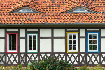 Frontal view of a traditional half-timbered house with colorful windows in Germany