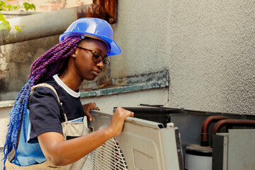 Qualified expert taking apart rusty condenser front grill in order to start reconditioning damaged...