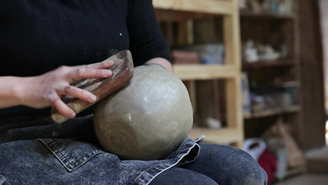 Mapuche Potter woman hands working with clay pot, craftswoman hands close up. Concept of creativity and indigenous art.