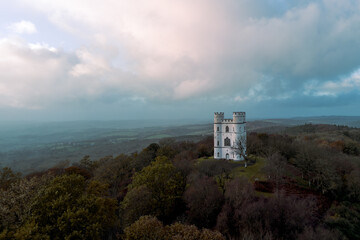 Haldon Belvedere (Lawrence Castle) in Haldon forest, Devon during golden hour with a stormy sky. 