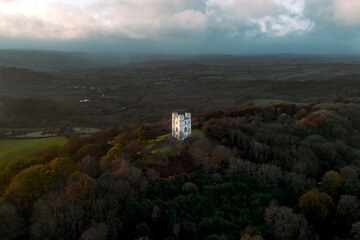 Haldon Belvedere (Lawrence Castle) in Haldon forest, Devon during golden hour with a stormy sky. 