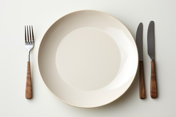 A plain ceramic plate and cutlery set, awaiting custom designs for a unique dining experience. Generative Ai.