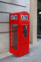 Fototapeta premium British style red booth with ATM machine in Grand Rapids, Michigan.