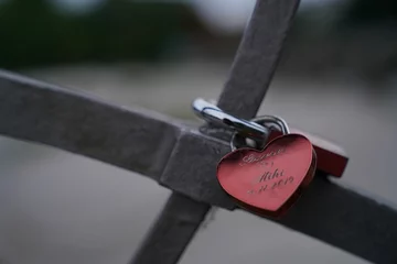  Closeup of a heart-shaped lock on a bridge as a concept of eternal love © Wirestock