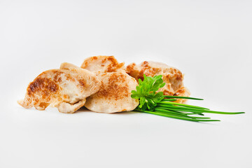 Chicken fillets fried until half cooked, semi-finished product with fresh herbs on a white background. Fast cooking.Fast homemade food.Fast food. Quick cooking at home. Copy space.