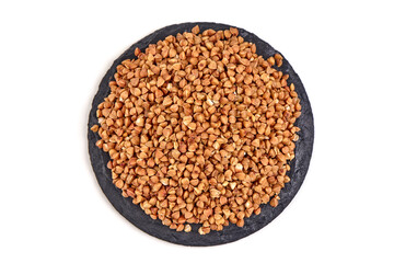 Raw buckwheat grains, isolated on white background.