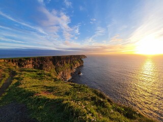 The Cliffs of Moher are sea cliffs located at the southwestern edge of the Burren region in County...