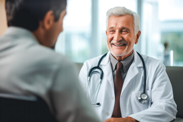 Fototapeta premium Elderly male doctor with a joyful smile meeting his patient at the clinic