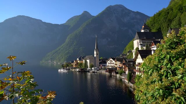 Hallstatt Village Ferry Departure Austria 4K UHD. The passenger ferry departs Hallstatt village on Hallstatter Lake in the Austrian Alps in the region of Salzkammergut, Austria. 4K, UHD.
