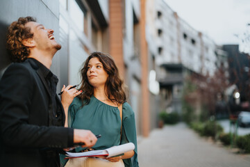 Diverse group of business professionals discussing growth strategies, analyzing markets, and gathering info outdoors in an urban area. Collaboration and teamwork fuel their drive for success.