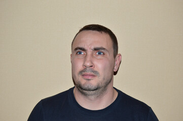 Obraz premium portrait of a young handsome man with blue eyes, light stubble and various emotions. young people leading a healthy lifestyle, open to communication, positive and friendly