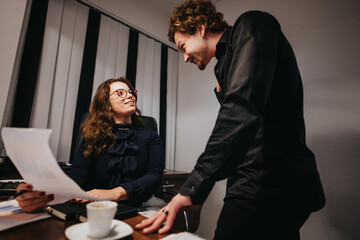 Innovative Corporate Partners Discussing Market Analysis and Revenue Growth Strategies in Modern Office