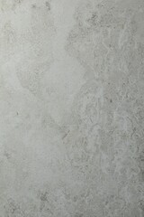 Texture of light grey stone surface as background, closeup
