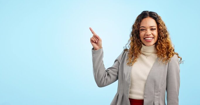 Happy business woman, pointing and advertising in marketing on mockup against a blue studio background. Portrait of female person or employee smile showing advertisement, list or product information