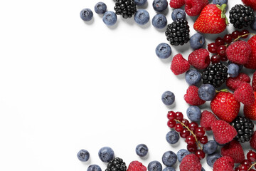 Many different fresh berries on white background, flat lay. Space for text