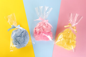 Packaged sweet cotton candies on color background, flat lay - obrazy, fototapety, plakaty