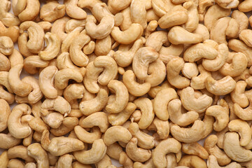 Many tasty cashew nuts as background, top view