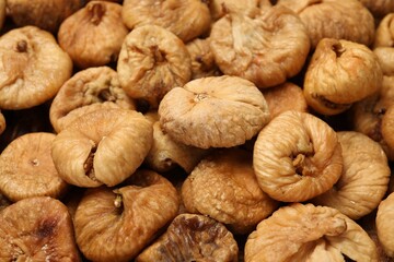 Many tasty dried figs as background, closeup
