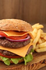 Delicious burger with meat cutlets, cheese, vegetables and lettuce on wooden table, closeup