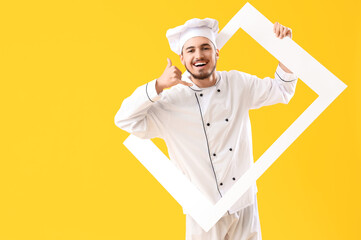Male chef with frame showing "call me" gesture on yellow background