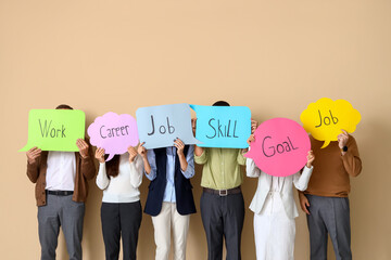 Business people holding speech bubbles with words on beige background