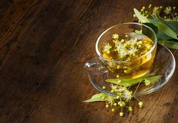 a cup of linden tea on an old wooden table