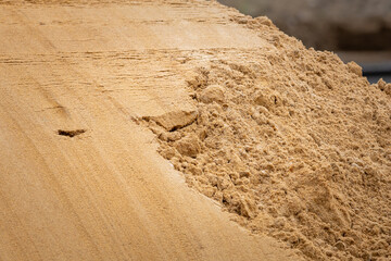 Pile of sand close-up. Bulk material for construction or repair. A pile of clean sand on a...