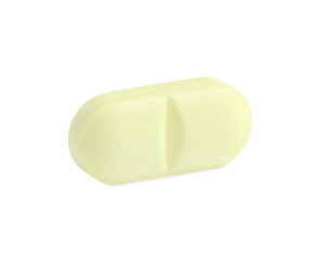 One yellow pill isolated on white. Medicinal treatment