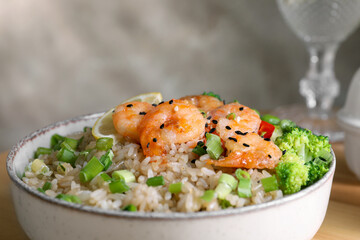 Tasty rice with shrimps and vegetables in bowl, closeup