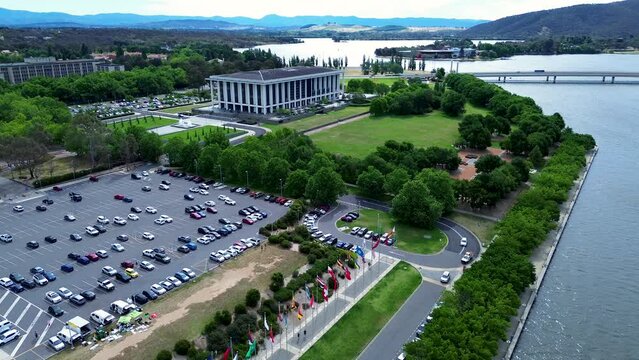 Drone aerial shot of carpark Lake Burley Griffin National library Questacon Parliamentary triangle zone politics travel tourism state circle technology flags Canberra ACT Australia 4K