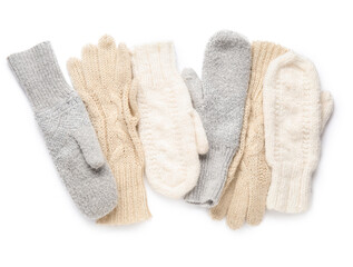 Set of warm mittens and gloves on white background