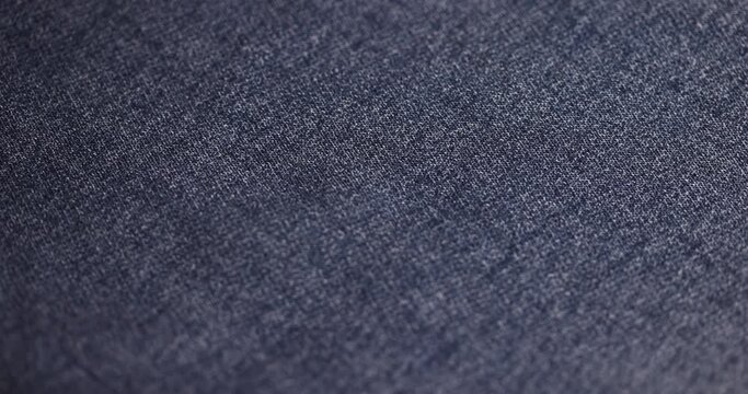 blue denim fabric made of cotton, details of a piece of clothing sewn from blue denim