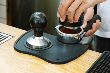Close up Barista hand making a coffee equipment.