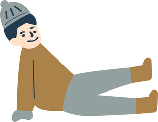 A boy is sitting on the ground in the winter