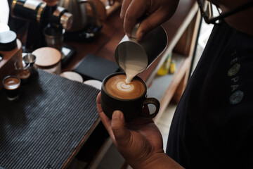 latte art making process in cafe background
