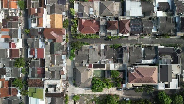 Aerial view of Solo City with buildings, crowded vehicles traffic in morning sunlight. Surakarta cityscape urban landscape. Population density is displacing agricultural land and forests.