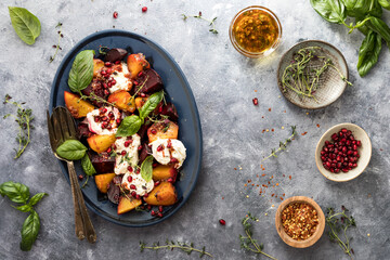 A platter of roasted beets topped with pomegranate, herbs and burrata cheese.