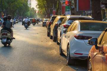 Rows of cars parked on the roadside in Hanoi street