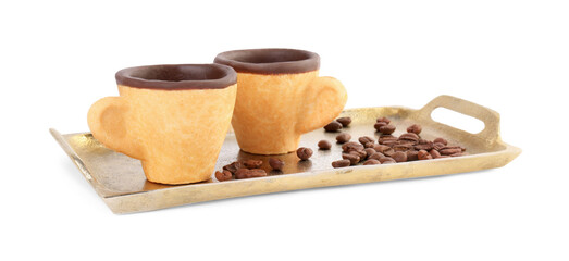 Tray with edible espresso cookie cups and roasted beans isolated on white