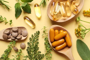 Fotobehang Different pills and herbs on pale orange background, flat lay. Dietary supplements © New Africa