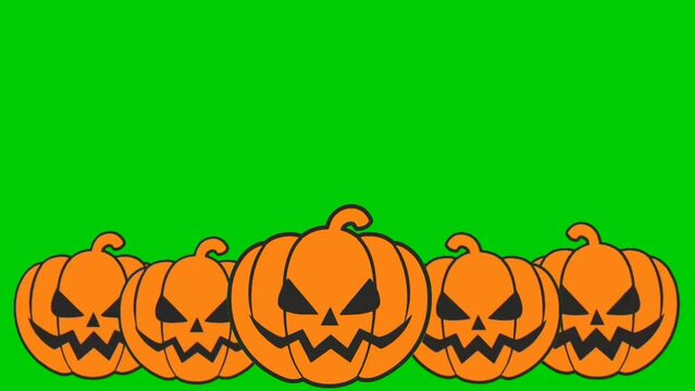 Halloween background with laughing pumpkins falling from top of the green screen with copy space