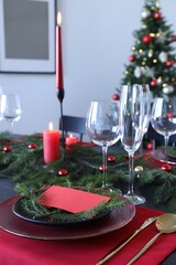 Elegant Christmas table setting with blank place card and festive decor
