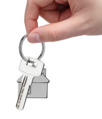 Woman holding key with keychain in shape of house isolated on white, closeup