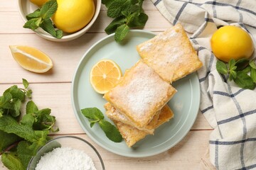 Tasty lemon bars with powdered sugar and mint on wooden table, flat lay