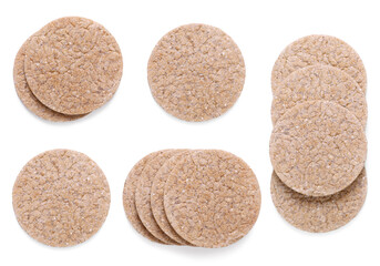 Tasty crispbreads on white background, top view